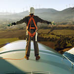 Man standing on wind turbine